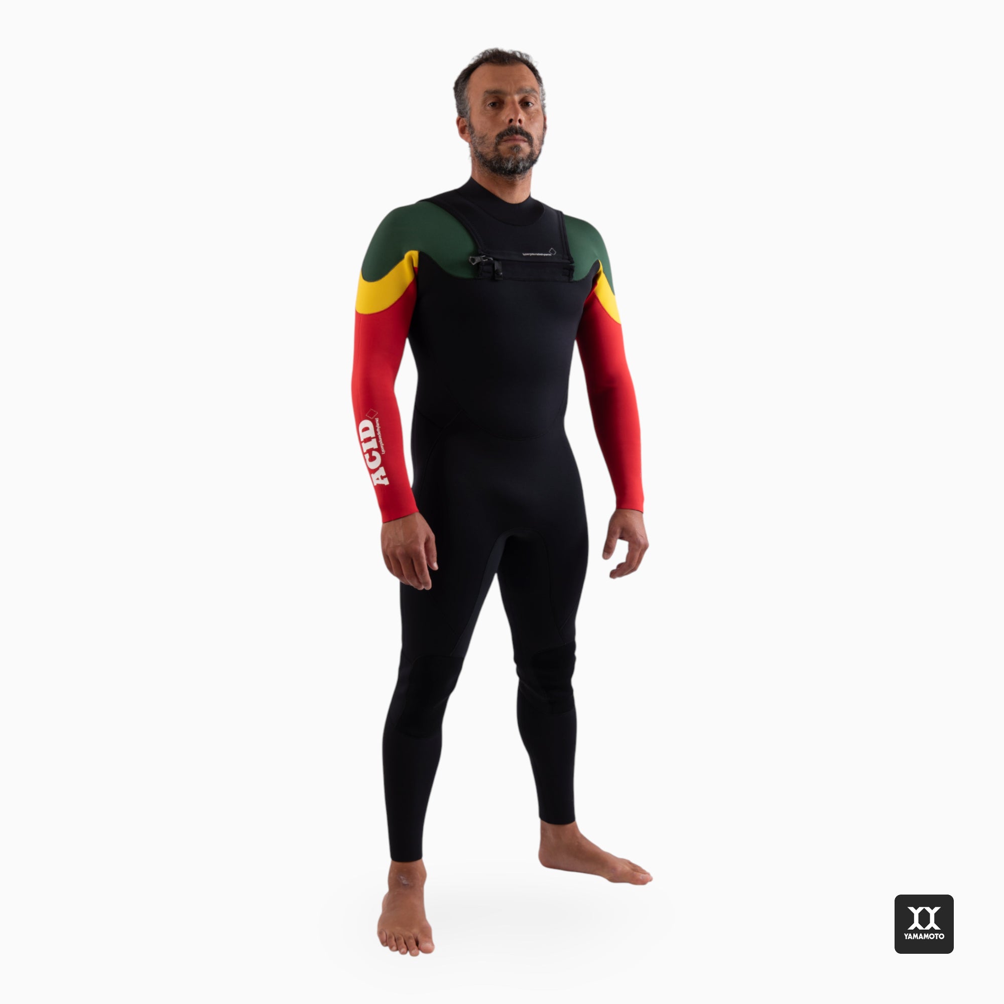 Surfer wearing a black wetsuit with red and yellow sleeves on a white frontbackground