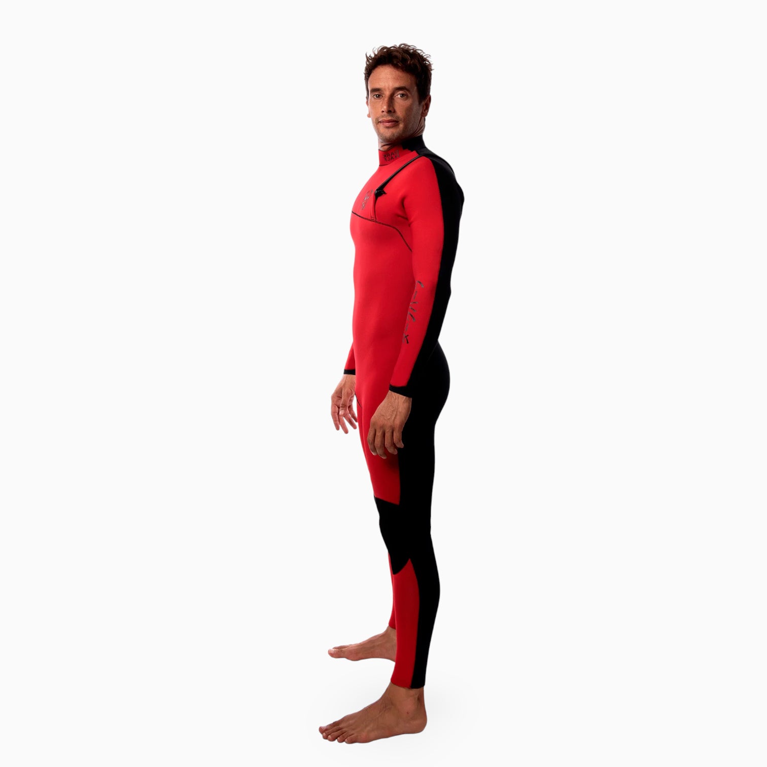 Surfer wearing a red and black JANGA Dark Half wetsuit on a white background