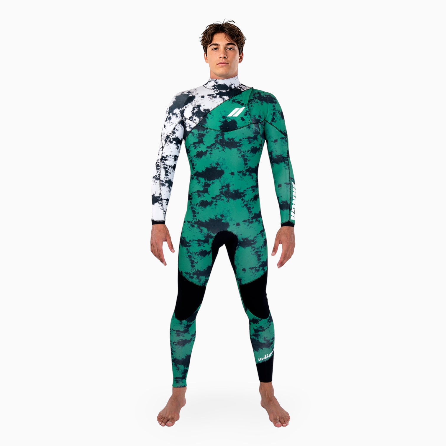 Surfer wearing JANGA INDIGENT Green and black camouflage wetsuit with white accents on a white background