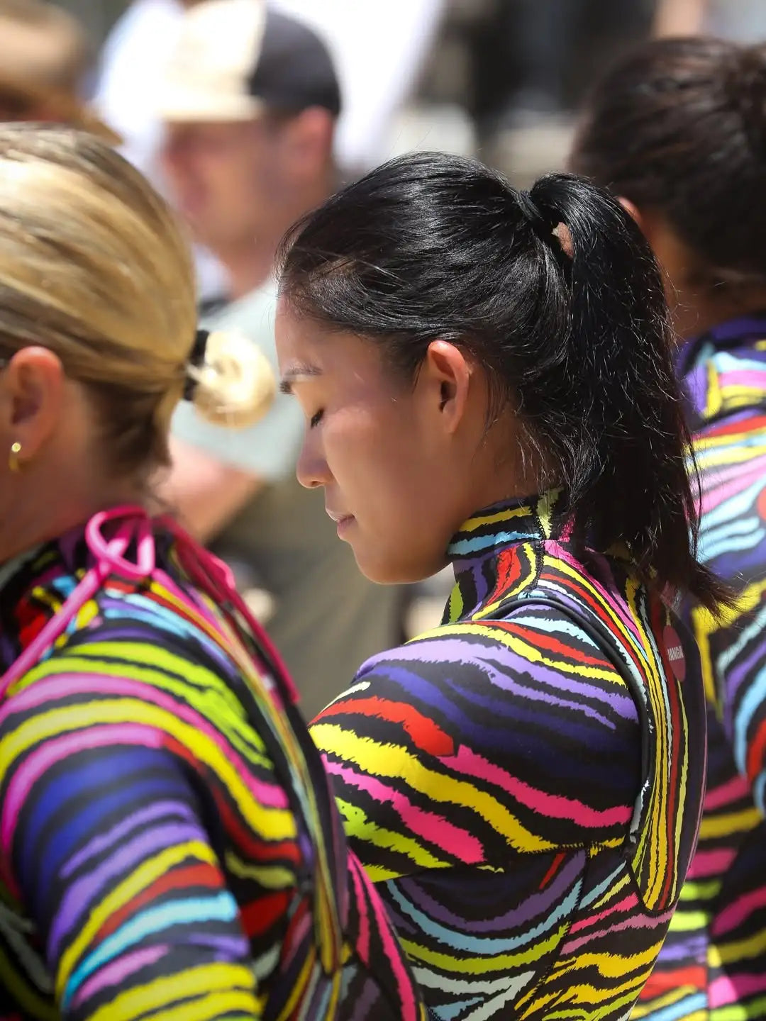 Two women in colorful striped JANGA wetsuits