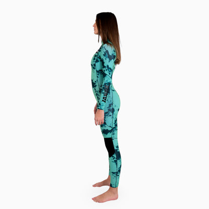 Woman wearing a teal JANGA TIE DYE wetsuit on a white background