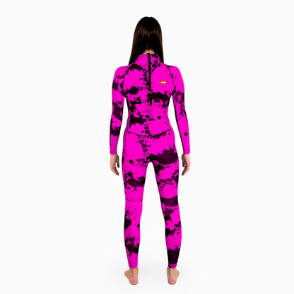 Woman wearing a pink JANGA TIE DYE wetsuit on a white background