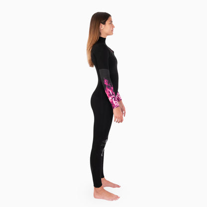 Woman wearing a black JANGA CHOSEN wetsuit with pink fire patterns on a white background