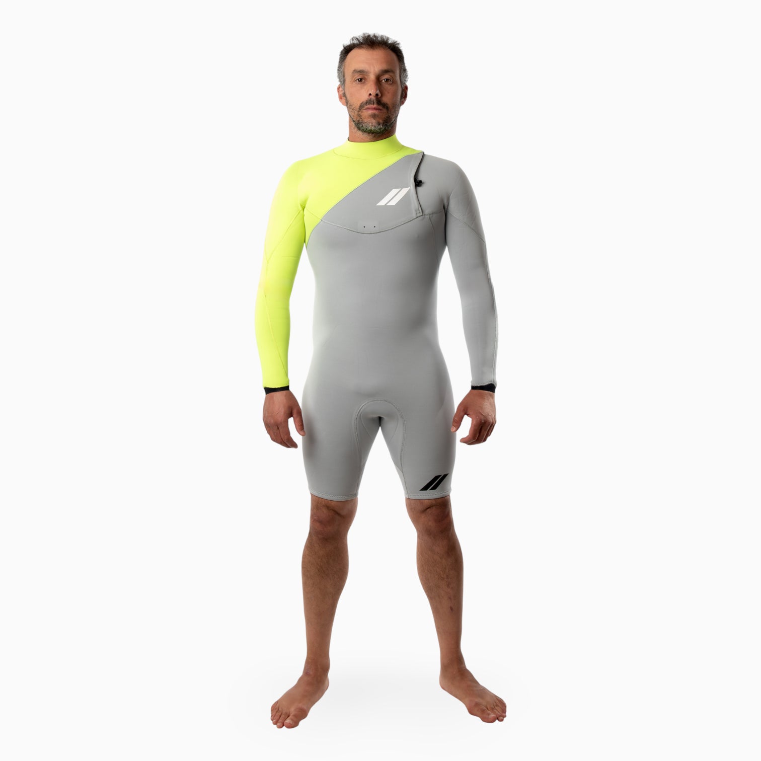 Surfer wearing a JANGA INDIGENT long sleeved spring gray and neon yellow wetsuit on a white background