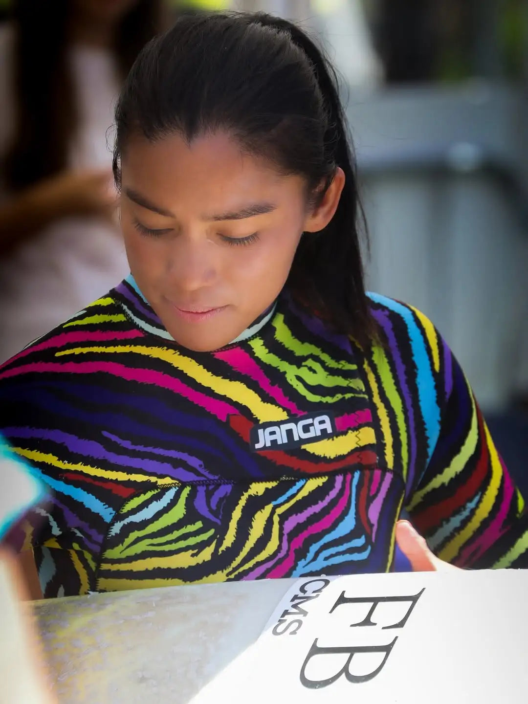 Surfer marybianco25 wearing a colorful zebra-striped JANGA wetsuit