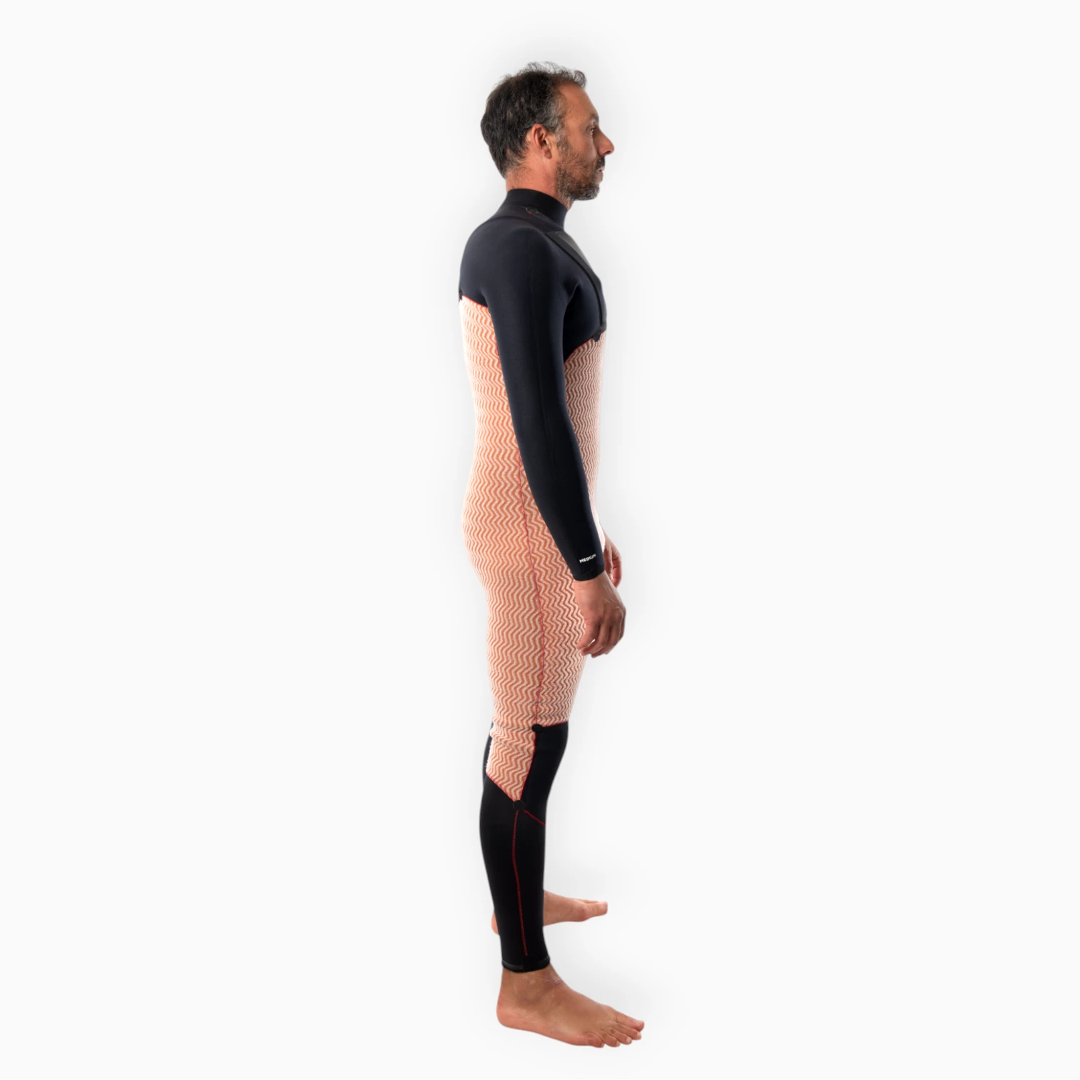 Male surfer wearing JANGA black wetsuit - Chosen Ring of Fire - thermal fleece inner lining side view
