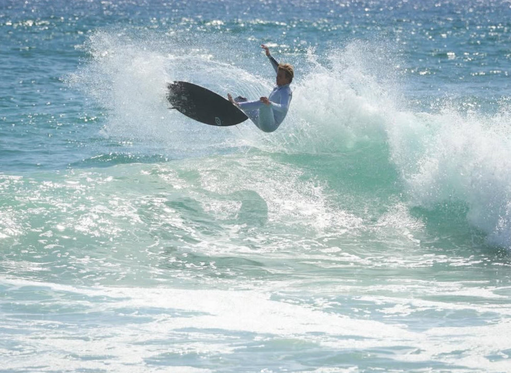nathanssantiago25 surfing on a wave in the ocean